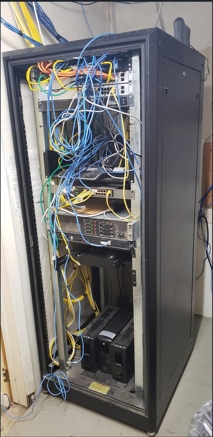 Before: rack with unmanaged cable bundles, server mid-stack, UPS units loose on the cabinet floor